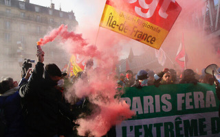 Protesters march behind a banner reading 'Paris will block the far right,' during a demonstration against French presidential candidate Eric Zemmour, on December 5, 2021, in Paris. (AP Photo/Michel Spingler)