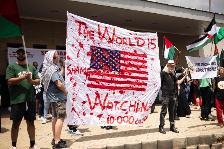 Protestors carry placards during a free Palestine protest at the United States Consulate as part of a global day of action in support of a free Palestine, in Johannesburg, South Africa, 13 January