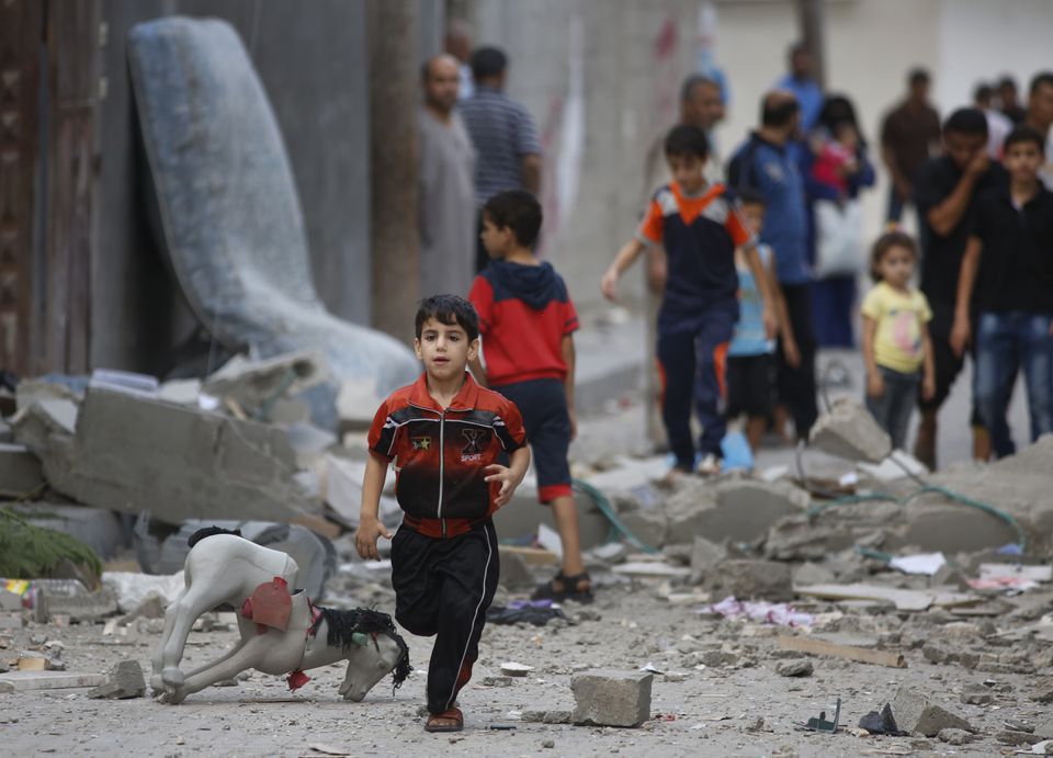 A Palestinian child runs on debris from a house that was destroyed Saturday in an Israeli strike in Beit Lahiya, Gaza Strip. AP Photo/Lefteris Pitarakis