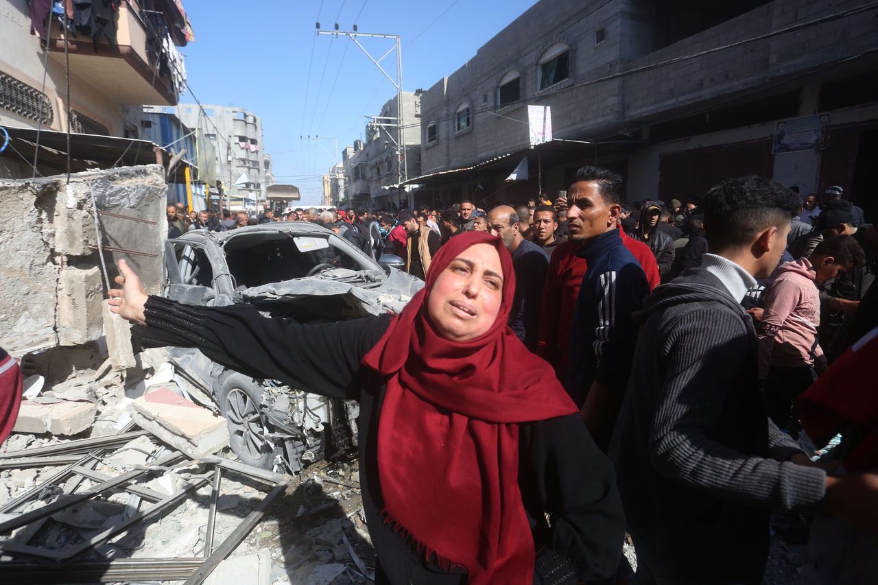 People gather in front of a building destroyed in an Israeli airstrike in the southern Gaza Strip city of Rafah, on Feb. 24, 2024.