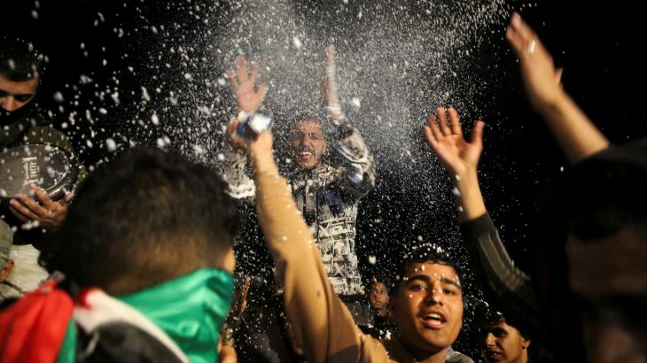 Palestinians react as they wait for news of a ceasefire deal with Israel