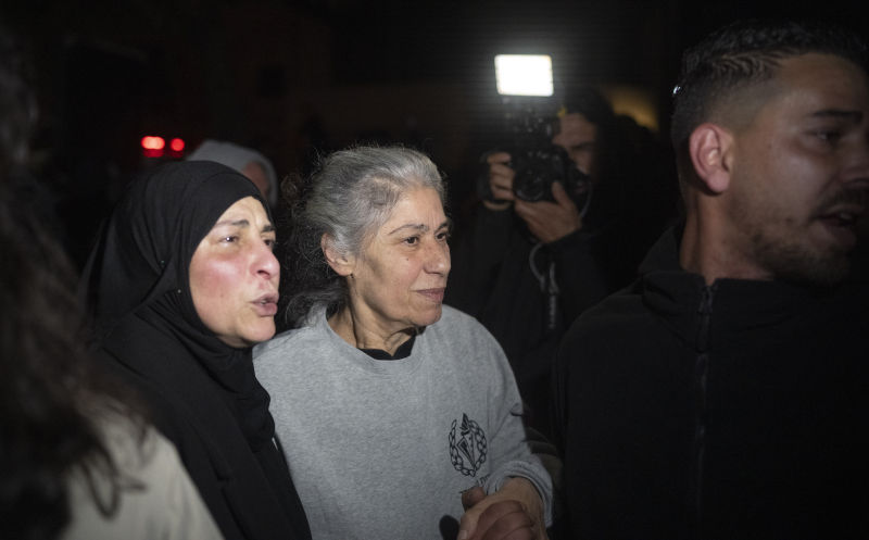 Khalida Jarrar, 62, a leading member of the Popular Front for the Liberation of Palestine, is greeted after disembarking from a bus following her release from an Israeli prison, in the West Bank city of Beitunia, early Monday, Jan. 20, 2025. Image:AP/AAP /Leo Correa