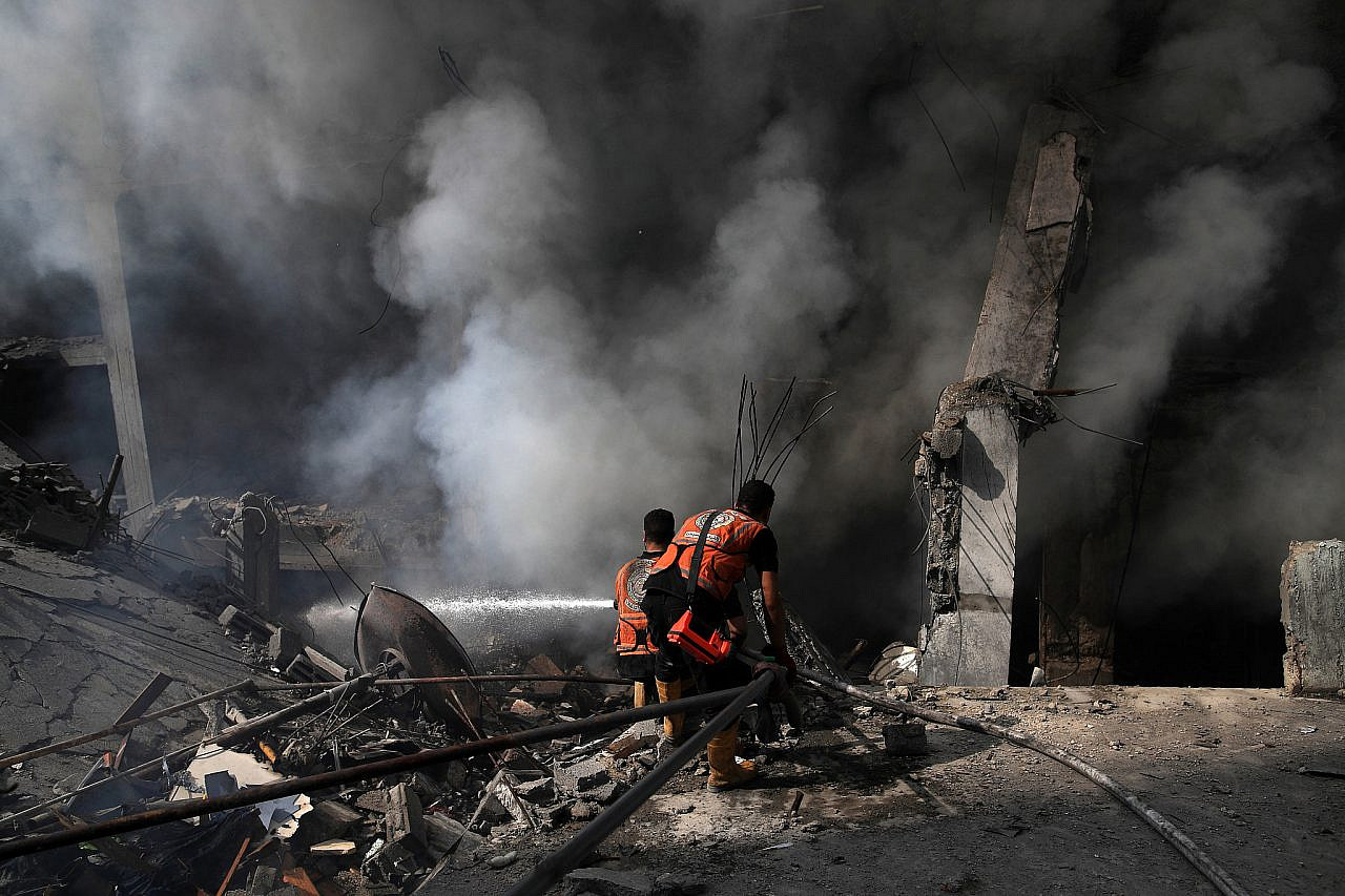 Members of the Civil Defense intervene in the immediate aftermath of an Israeli bombing in the Sheikh Radwan area north of Gaza City, Gaza Strip, October 23, 2023. (Mohammed Zaanoun/Activestills)