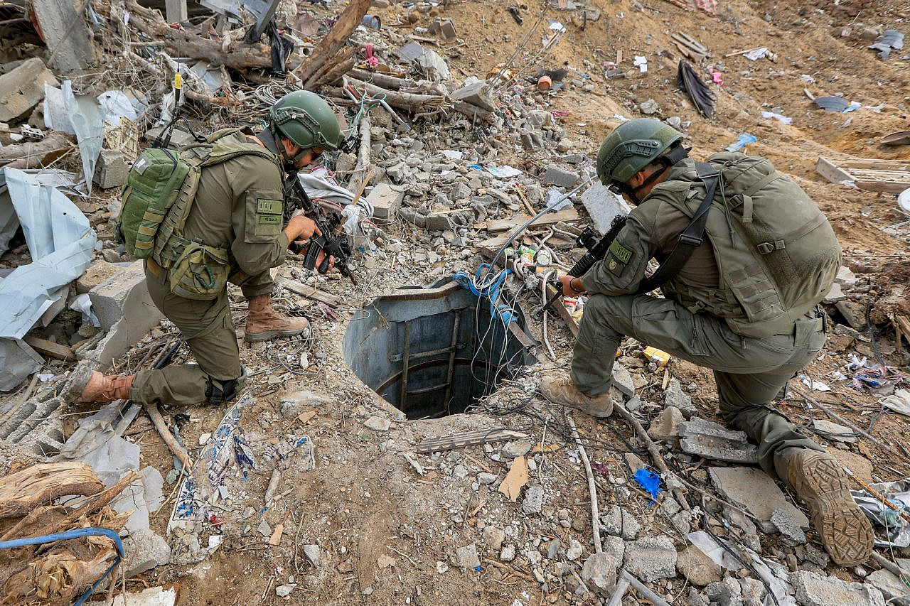 Israeli soldiers stand at the entrance to an underground tunnel used by Hamas in Beit Lahia, northern Gaza Strip, November 28, 2024. (Oren Cohen/Flash90)