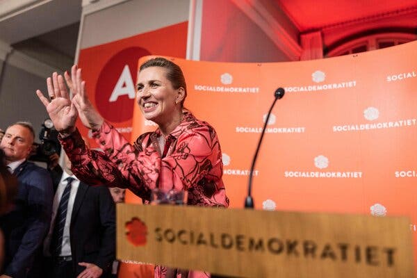 Prime Minister Mette Frederiksen waving.