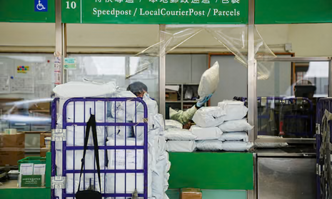 A postal worker handles packages at Hong Kong’s general post office