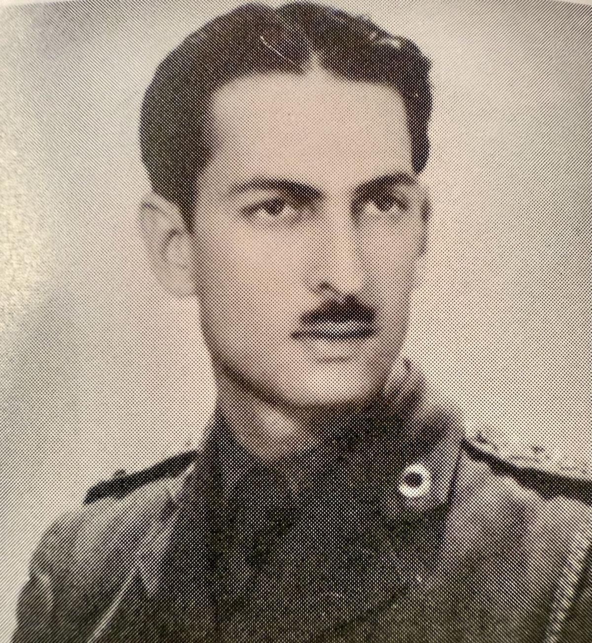 A black and white picture of Yavar as a young man, with a serious _expression_ 