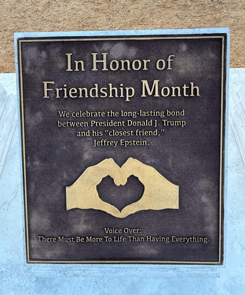 Another plaque states the statue is meant to 'celebrate the long-lasting bond' between Trump and Epstein