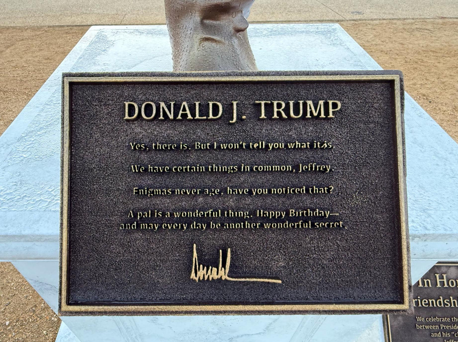 A plaque below the statue includes an excerpt from the alleged bawdy birthday card from Trump to Epstein for his 50th birthday, which the president has denied writing