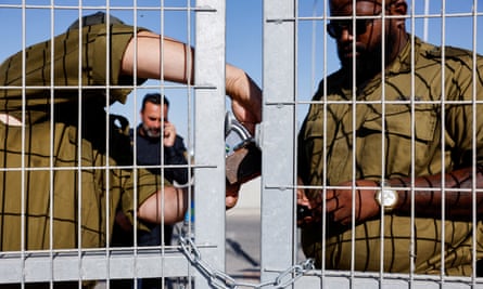 Soldiers lock a gate from the inside at Sde Teiman detention facility