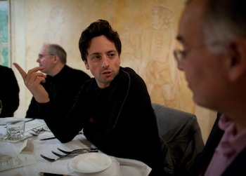 Mr Brin speaking at a dinner table