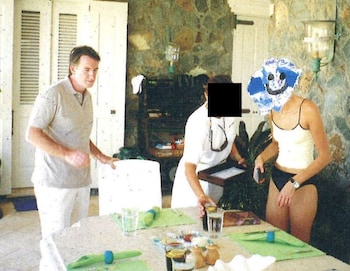 Mandelson stands with two women