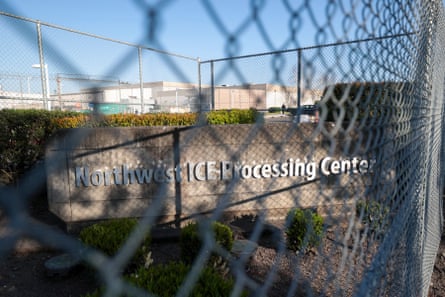 The Northwest ICE Processing Center, Tacoma, Washington. It has been photographed through a wire fence