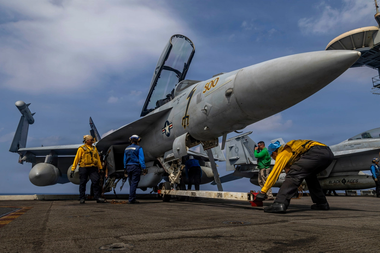 This photo provided by the U.S. Navy shows sailors preparing a Boeing EA-18G Growler on the flight deck of the Nimitz-class aircraft carrier USS Abraham Lincoln in the Indian Ocean.