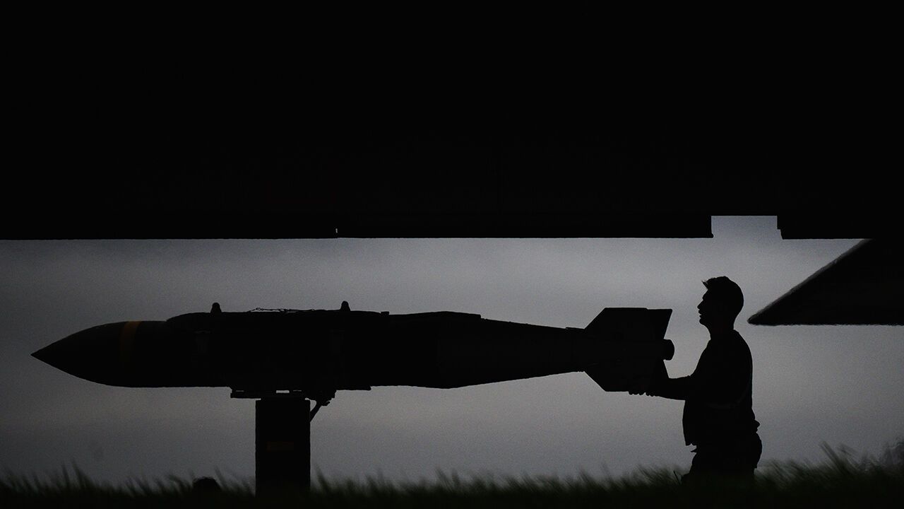 Munitions, believed to be JDAM bunker-busting bombs, are loaded into a US Air Force B-1B Lancer bomber 