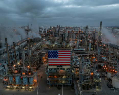 aerial view of oil refinery with american flag in center