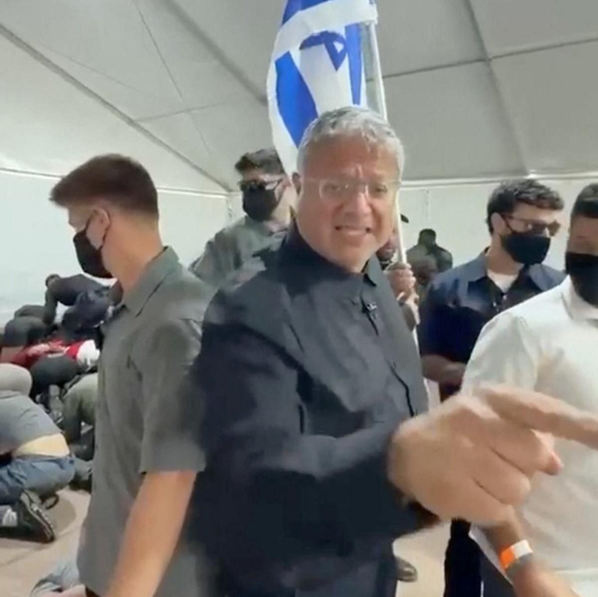 Israeli National Security Minister gestures in front of an Israeli flag while touring  a facility in the Israeli port of Ashdod where pro-Palestinian activists from a Gaza-bound flotilla are being detained (20 May 2026)