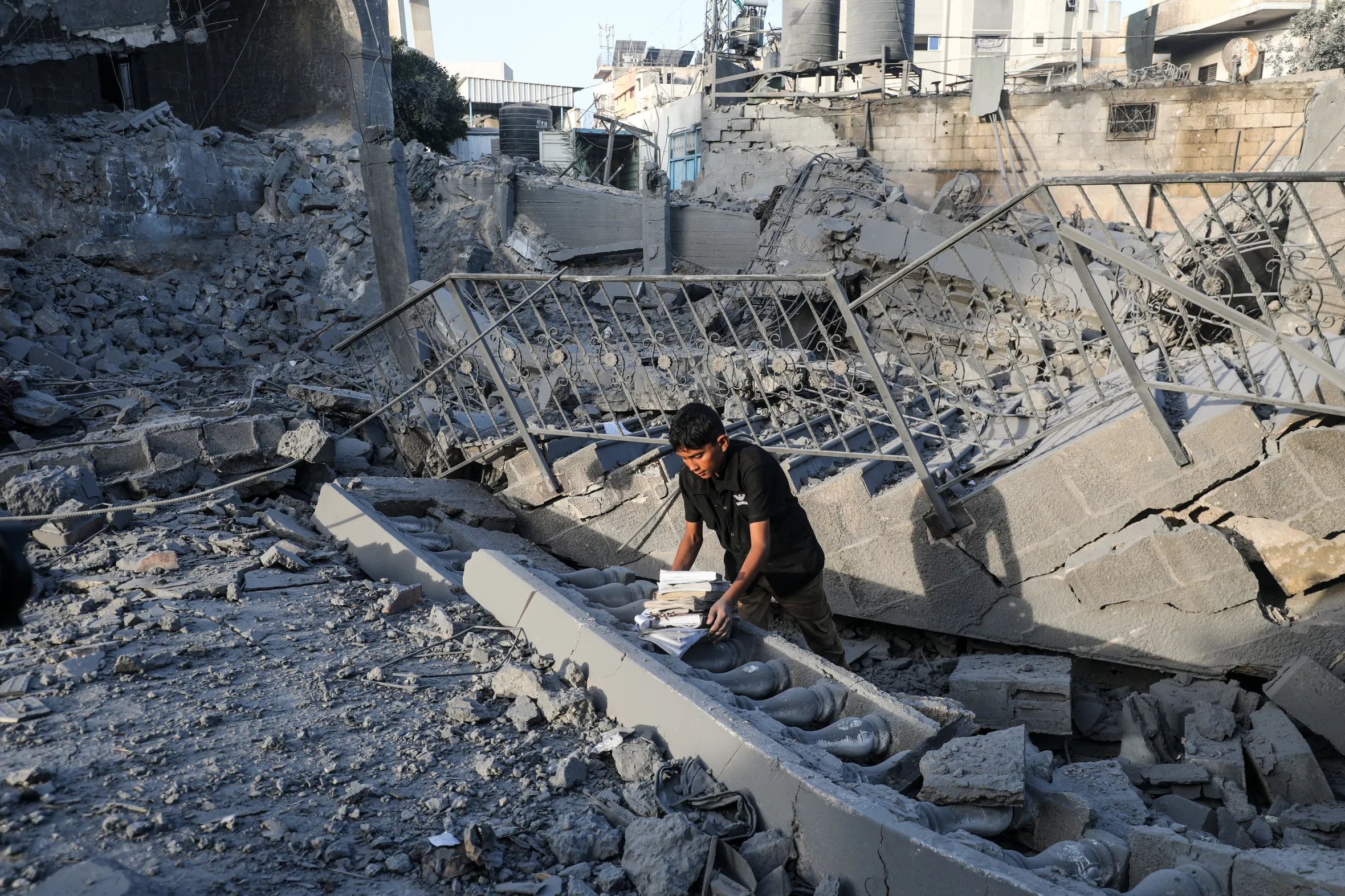 A young Palestinian among the rubble of the heavily damaged Abu Salim Mosque and surrounding neighborhood in Deir al-Balah.