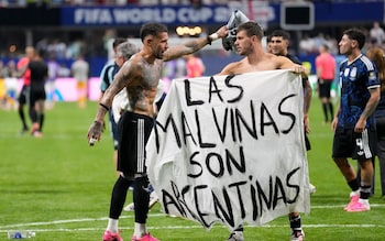 Argentine players hold up provocative banner with the same phrase, 'Las Malvinas son Argentinas' at the World Cup